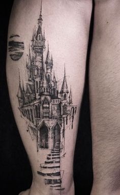 a man's leg with a castle tattoo on it