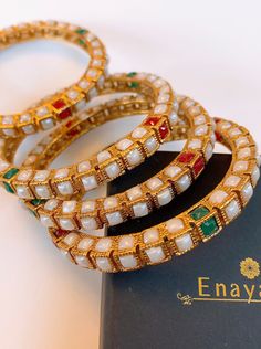 Heavy White Bracelets For Festive Occasions, Festive White Hand Set Bangle, Festive White Hand-set Bangle, Traditional Festive Stackable Bracelets, Traditional Stackable Bangle For Festive Occasions, Festive Traditional Stackable Bracelets, Traditional Festive Stackable Bangle, White Cutdana Bangle As Gift, Bollywood White Bangle For Diwali