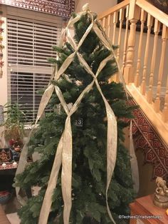 a christmas tree that has been decorated with ribbons