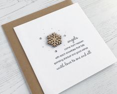 a card with a wooden snowflake on it