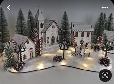 a christmas village with lights and trees