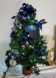 a small christmas tree decorated with blue and silver decorations