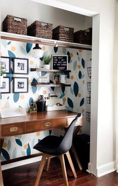 a home office with wallpaper and shelves