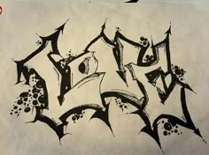 some type of graffiti written in black ink on white paper with red and blue marker markers