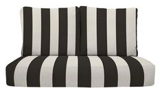 a black and white striped couch with two pillows on it's backrests