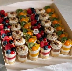 a box filled with lots of different types of desserts on top of each other