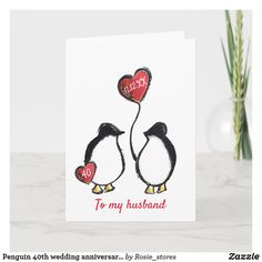 a card with two penguins holding hearts and the words i love you to my husband