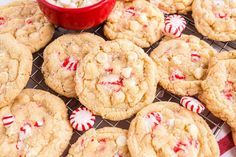 white chocolate peppermint cookies with candy canes on a cooling rack next to a bowl of marshmallows