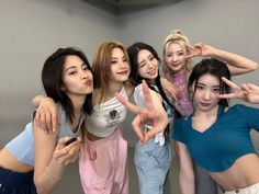 group of young women posing for the camera with their fingers in the shape of a peace sign