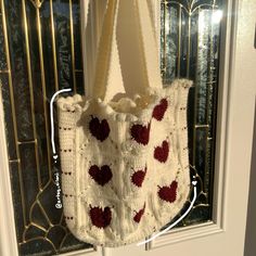 a crocheted bag hanging on the front door