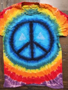 This tie dye is our Peace Sign standard. These shirts are done on Gildan brand tees and are super comfortable. Available in sizes S-2X. Please note, while most orders of our standard dyes ship next day - if your size is out of stock it will be 5-7 days for shipping. Due to the nature of tie dye, there will be slight variations in each shirt. Peace Sign Tie Dye, Eye Pattern, Batik Shirt, Tie Dye Shirt, Dye Shirt, Mens T Shirts, Peace Sign, Fun Stuff, Batik