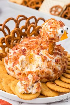 a plate with crackers and pretzels in the shape of a turkey on it