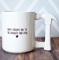 a white coffee mug with the words happy father's day to the handsome dad ever on it