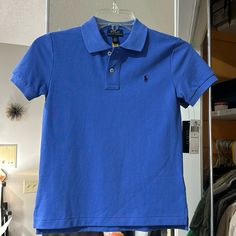 Nwt Ralph Lauren Polo. Size 7. More Dusty Pale Blue Than The Picture Shows. Blue Fitted Collared T-shirt, Blue Cotton Fitted Polo Shirt, Blue Fitted Cotton Polo Shirt, Fitted Blue Polo Shirt For Spring, Fitted Blue Cotton Polo Shirt, Blue Ralph Lauren Cotton Tops, Classic Blue Plain Top, Classic Fitted Blue T-shirt, Royal Blue Fitted Short Sleeve Top