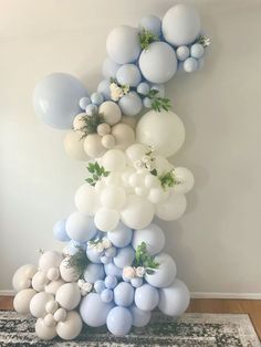 balloons and greenery are arranged in the shape of an eiffel tower