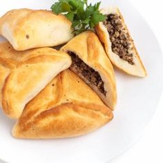 two pastries on a white plate with parsley