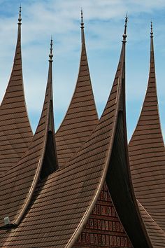 the top of a building with many pointed roofs