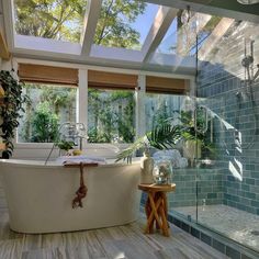 a bathroom with a large bathtub next to a walk in shower and two windows