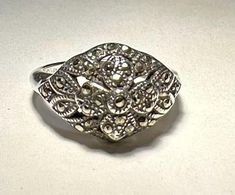 Very pretty sterling and marcasite ring. Finger size is 7 and is sizable. Marked and tested 925. PLEASE NOTE THAT ANY ORDERS EXPECTED BY CHRISTMAS SHOULD BE PLACED BY 12/13/24. Vintage Marcasite Ring Stamped 925, Marcasite Ring, Ring Finger, Durham, Rings Statement, Sterling Silber, Labour Day, Statement Rings, Beauty Book