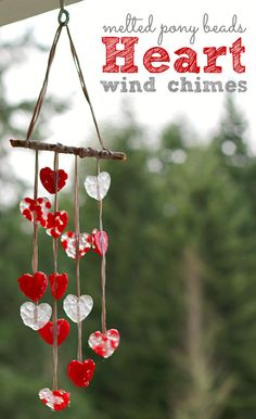 a wind chime made out of hearts hanging from a tree branch with text overlay that reads melted pony beads heart wind chimes