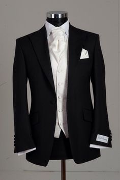 a black tuxedo with white shirt and bow tie on a mannequin