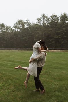 two people in a field hugging each other