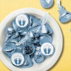 a white bowl filled with blue candies on top of a yellow table