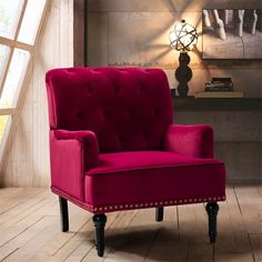 a red chair sitting on top of a hard wood floor