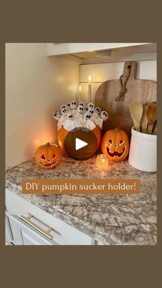 a kitchen counter topped with carved pumpkins and candles