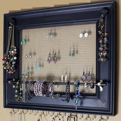 a wall mounted jewelry rack with earrings on it