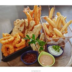 a tray with fries and dipping sauces on the side, along with other food items