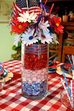 a patriotic centerpiece in a mason jar filled with candy