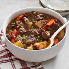 a white bowl filled with meat and vegetables