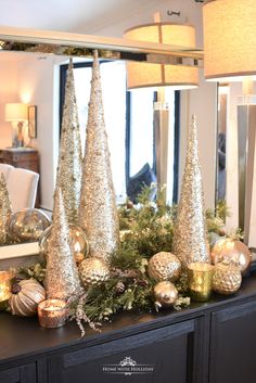 christmas decorations in gold and silver on a mantle