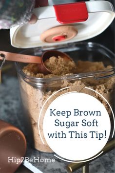 a container filled with brown sugar sitting on top of a counter next to a spoon