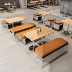 an empty cafeteria with tables and benches in the center, surrounded by other seating areas