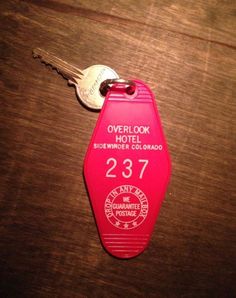 a pink keychain with the number 23 on it