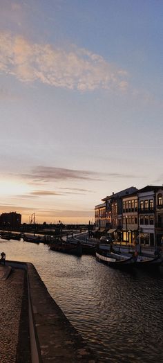 a body of water that has some buildings on the other side and boats in it