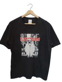 a black t - shirt with an image of a man on it