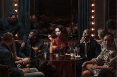 a group of people sitting around a table with drinks