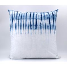 a blue and white pillow on a white background