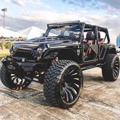 a black jeep parked on top of a parking lot