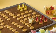 a cookie board with dices and candies on it