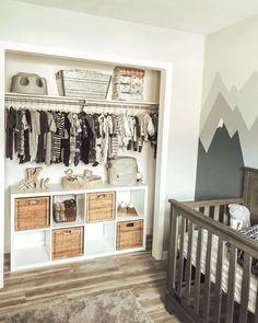 a baby's room with a crib and shelves filled with clothes, toys and other items