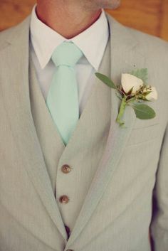 a man in a suit with a boutonniere on his lapel