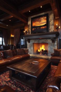 a living room with leather couches and a fire place in the center, along with a large painting on the wall