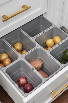 an organized drawer in the kitchen with potatoes, onions and avocados inside it