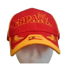 a red and yellow cap with the word spain printed on it's front side