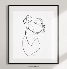 a line drawing of a dog's face in black and white, framed on a wall