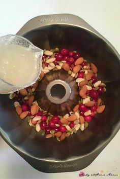 a metal bowl filled with nuts and other food